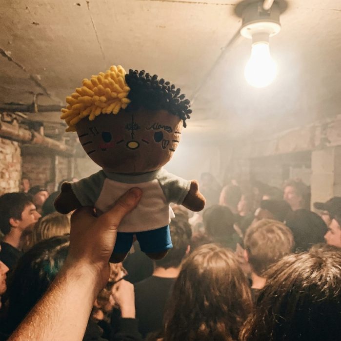 A plush raised in a concert crowd